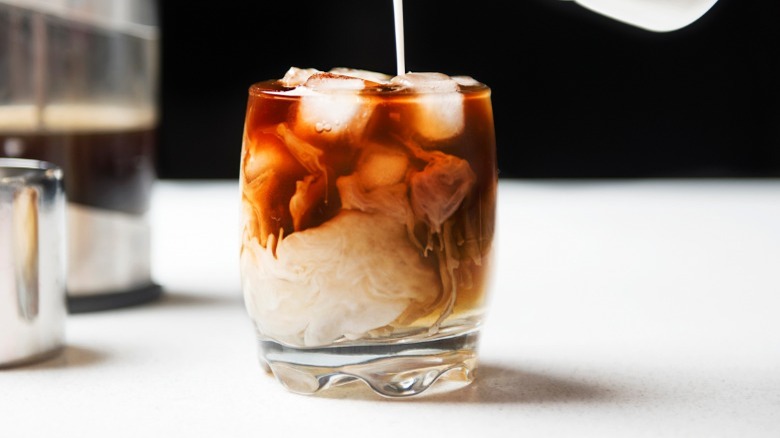 Milk poured into cold brew glass