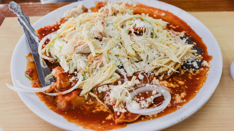 Chilaquiles with red sauce on a plate