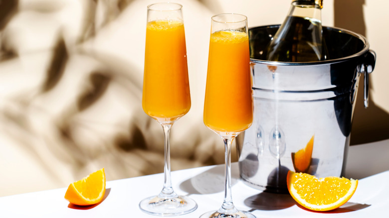 Two mimosa cocktails with orange slices