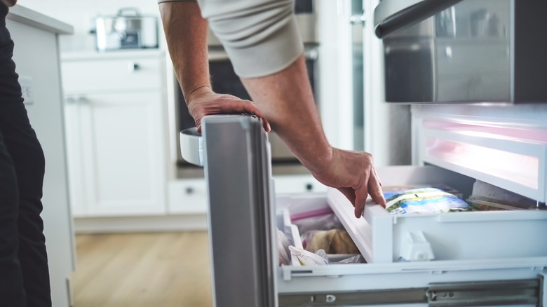 Person opening freezer