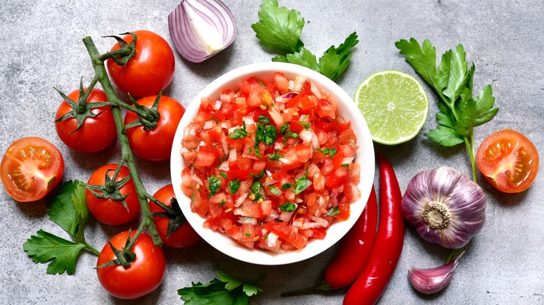 fresh salsa surrounded by vegetables 