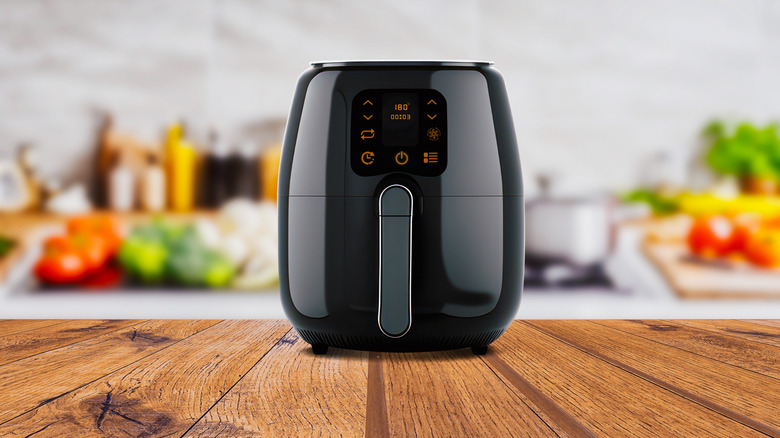 air fryer machine cooking potato fried in kitchen