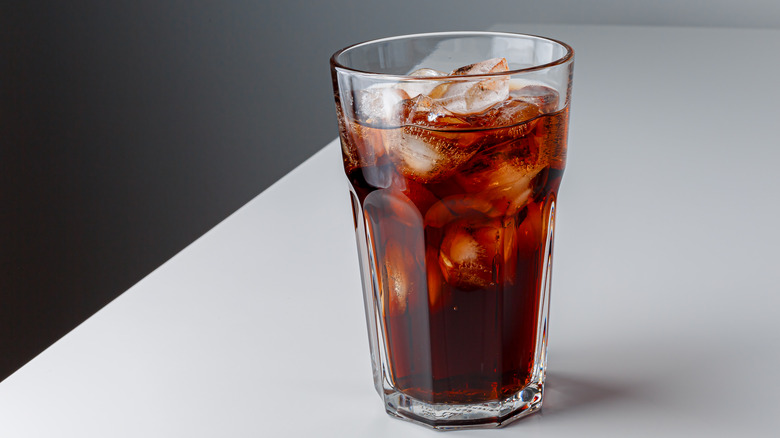 glass of cola on grey table