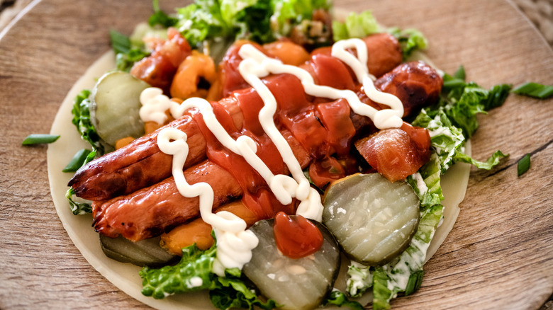 keto salad topped with hot dogs