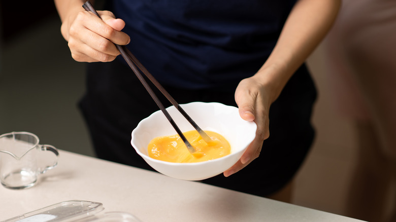 Stirring eggs with chopsticks