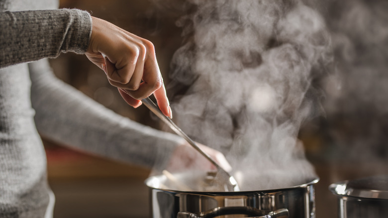  A person cooking with a pan