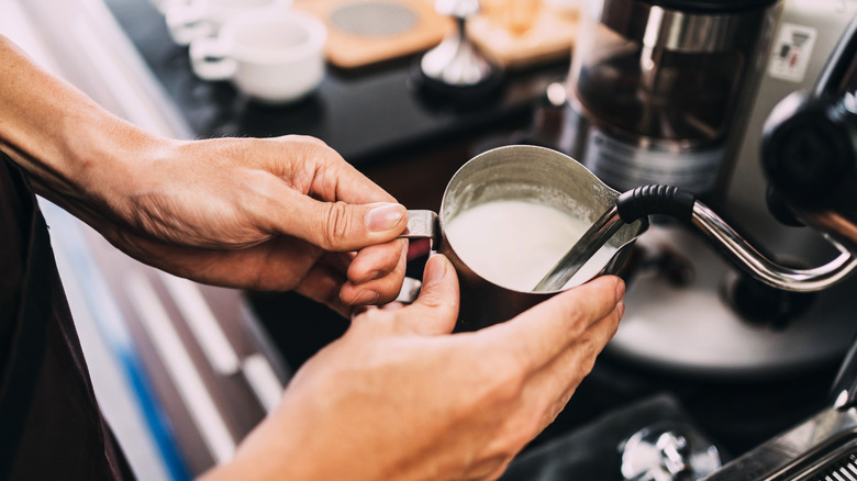 Person holding milk jug