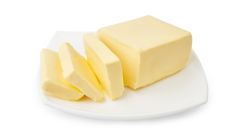 Sliced butter on white plate