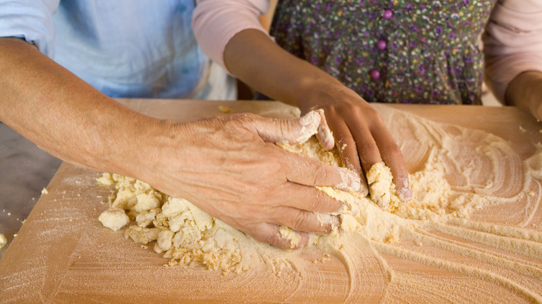 Kneading dough between hands