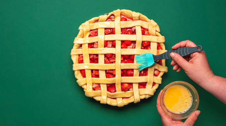 Person washing pie crust