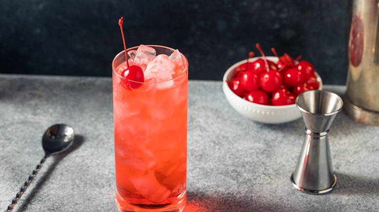 red cocktail with cherry garnish