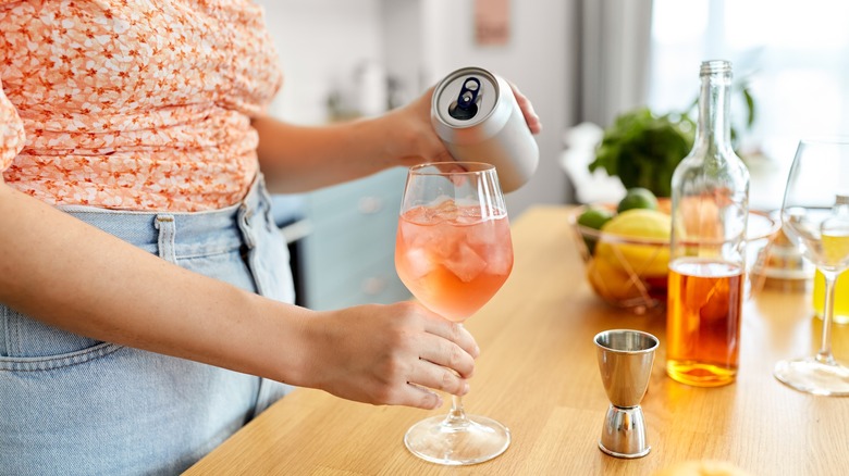 woman mixing a spritz cocktail