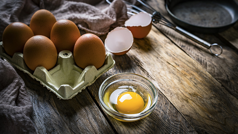 Cracked and whole raw eggs