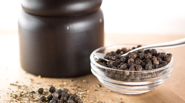 glass bowl of black peppercorns