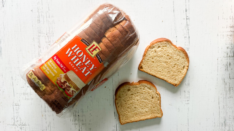 Honey wheat bread on white surface