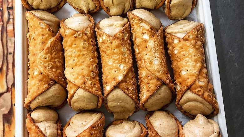 Rows of cannolis on baking tray