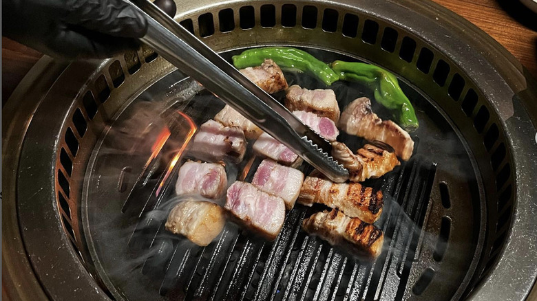 Nubiani flipping koream barbecue meat