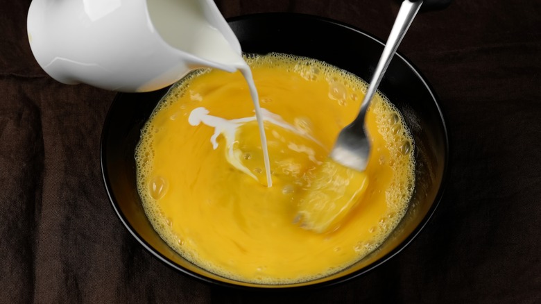 milk cascading into eggs