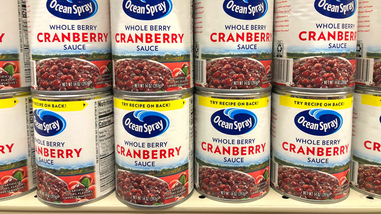 Whole berry cranberry sauce cans on a shelf