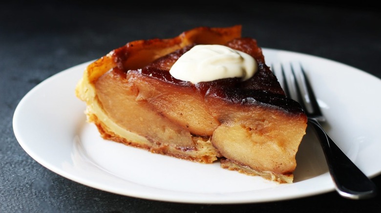 apple tarte tatin on plate with fork next to it