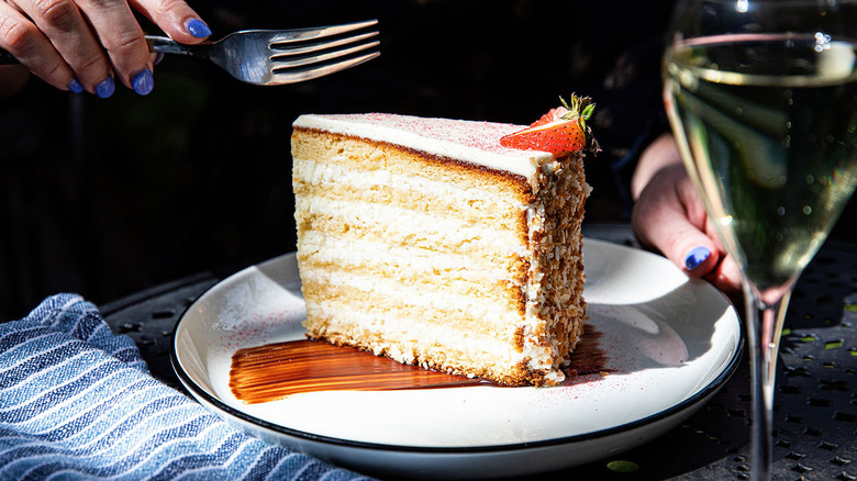 slice of layered coconut cake on plate