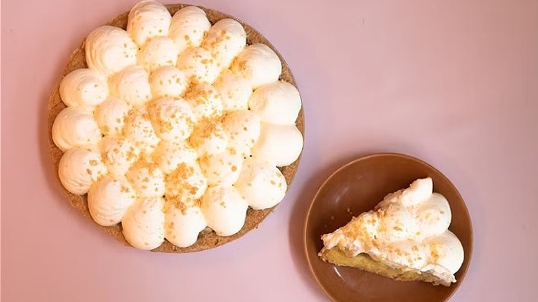 whole banana cream pie and one slice on a dish