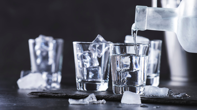 pouring water into ice glass