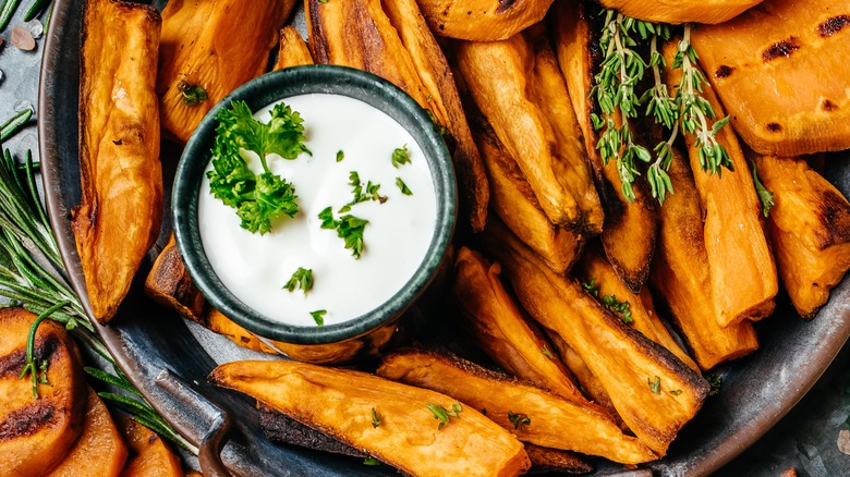 sweet potatoes fries surrounding dip cup