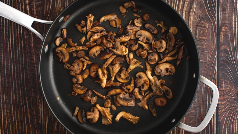 Mushrooms sautéing in pan
