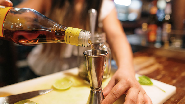 Woman pouring rum