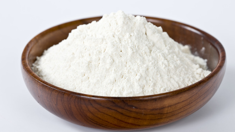 White flour in wooden bowl 