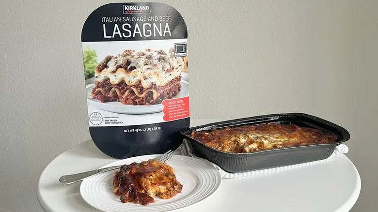 Cooked Italian sausage and beef lasagna in tray and on plate