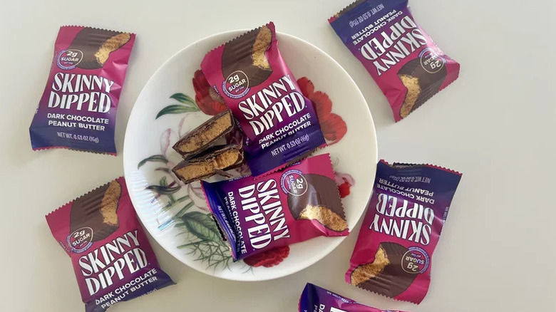 Skinny Dipped dark chocolate peanut butter cups on a plate