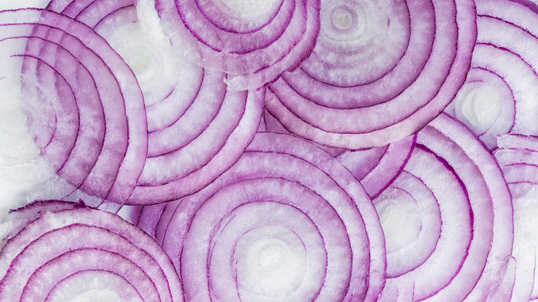 close up of thin red onion slices