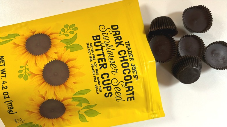 trader joes dark chocolate sunflower seed butter cups spilling out of bag onto table