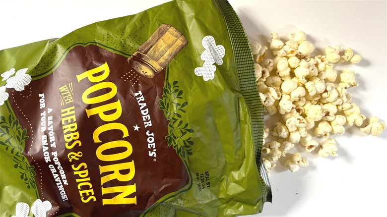 trader joes popcorn with herbs and spices spilling out of bag on table