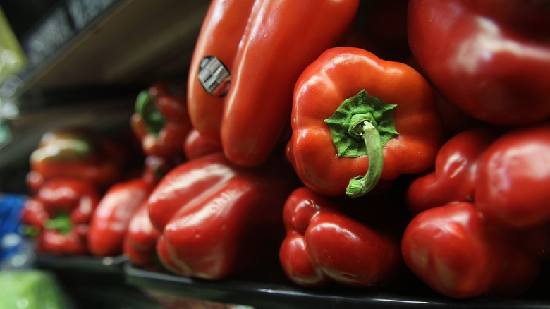 bell peppers on a shelf in a store