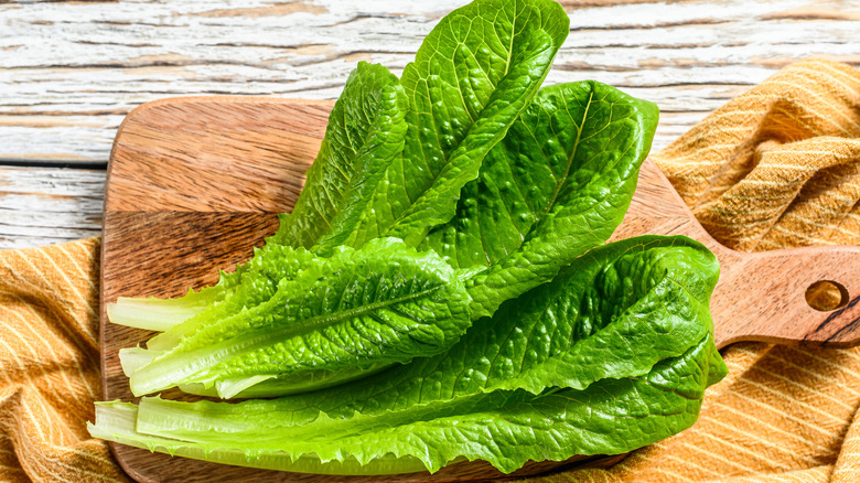 lettuce leaves on a cutting board