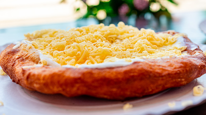 Hungarian lángos topped with cheese