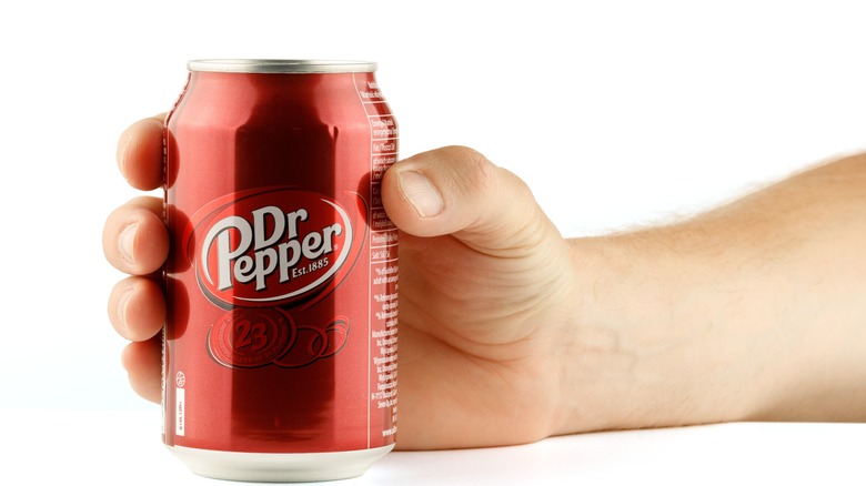 Hand holding Dr Pepper can