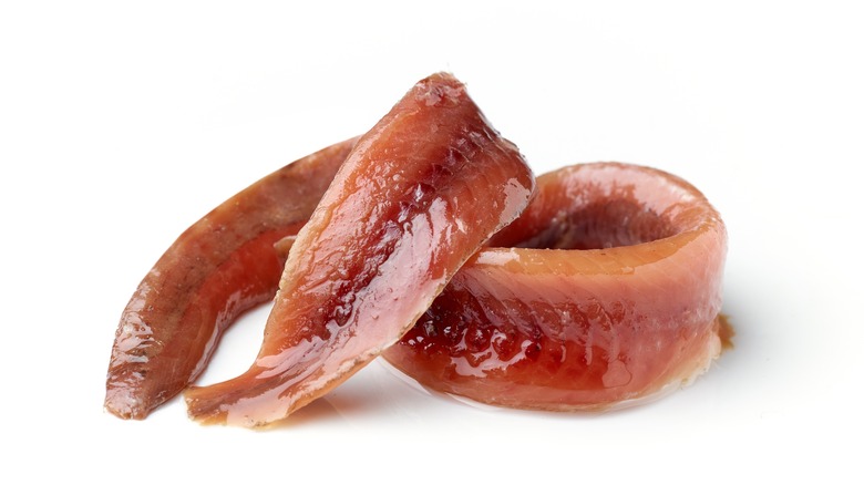 Anchovy fillets on white background