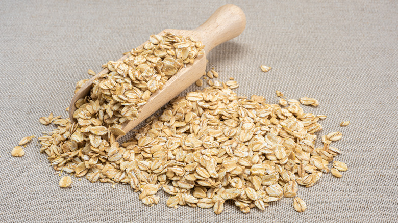 Dry oatmeal and wooden scooper