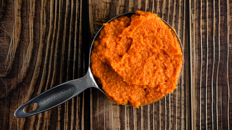 measuring cup full of pumpkin