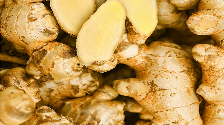 pile of fresh ginger roots with some cut lengthwise