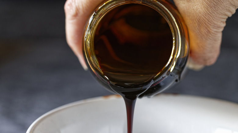 Pouring thick molasses into bowl