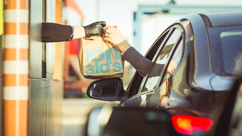 Food being handed through a drive-thru