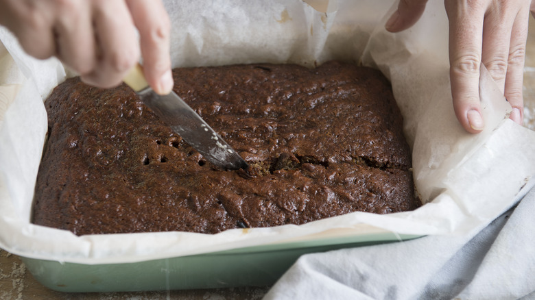 Slicing hot brownies with knife