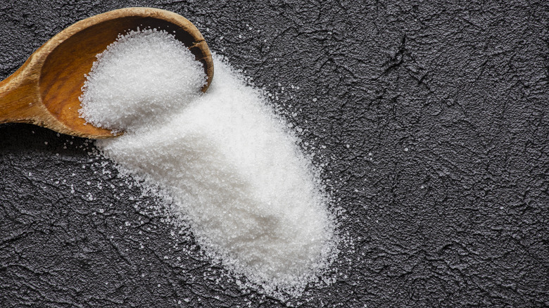 White sugar on grey background