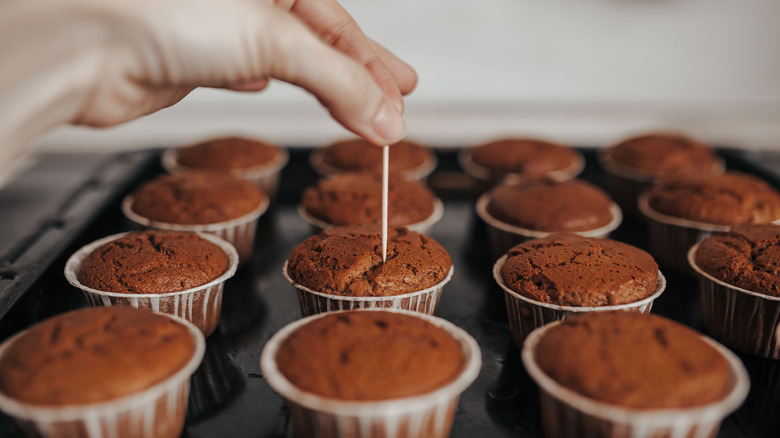 Poking toothpick into muffin