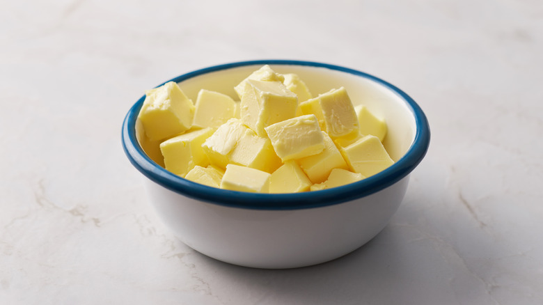 Cold butter cubes in bowl